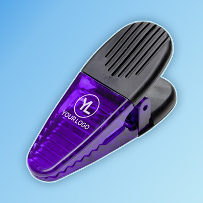 A photo of a transparent purple clip with YOUR LOGO HERE printed on it in white, with a black grip.