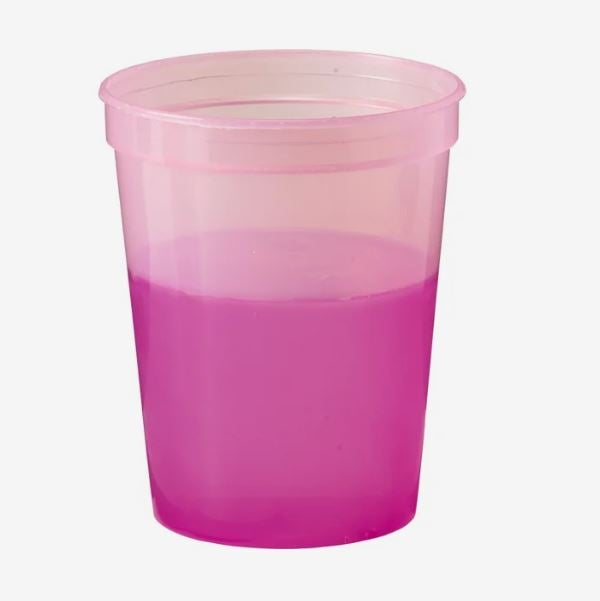 A photo of a plastic cup changing from light pink to magenta.