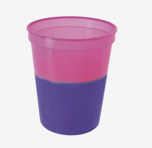 A photo of a plastic cup changing from pink to purple.
