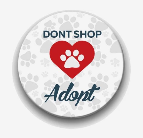 An ad saying Don't Shop, Adopt with a pawprint in a heart, printed on a circular magnet.