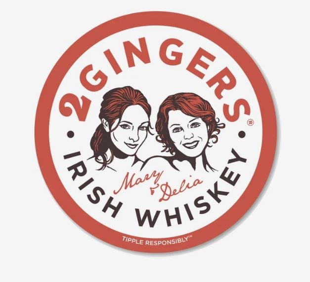 An ad for 2 Gingers Irish Whiskey with an illustration of Mary and Delia, with a red border, printed on circular magnet.