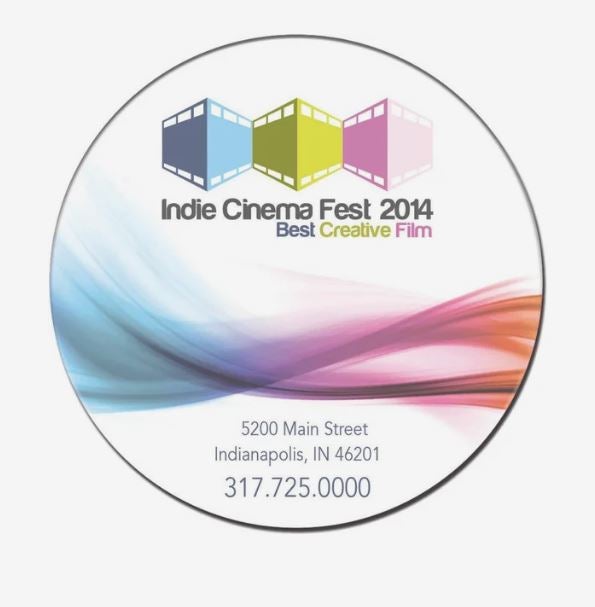 A colorful ad for Indie Cinema Fest 2014 printed on a circular magnet, with contact info printed at the bottom.