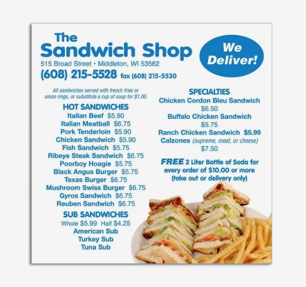 A photo showing a square magnet with an advert for The Sandwich Shop in blue font, with a list of the menu and a photo of sandwiches in the corner.