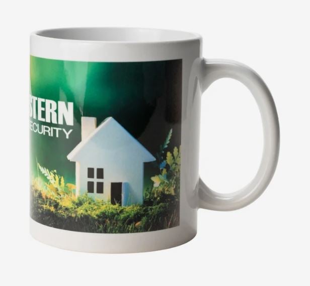 A white mug with a a green print on it.