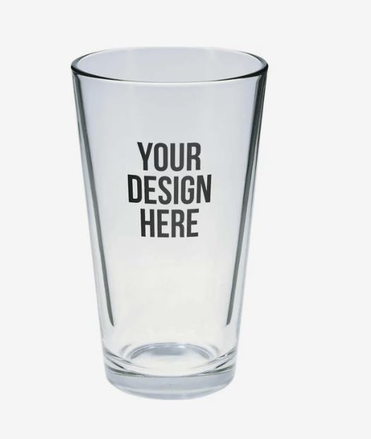 A photo of a shot glass with YOUR DESIGN HERE printed on it.