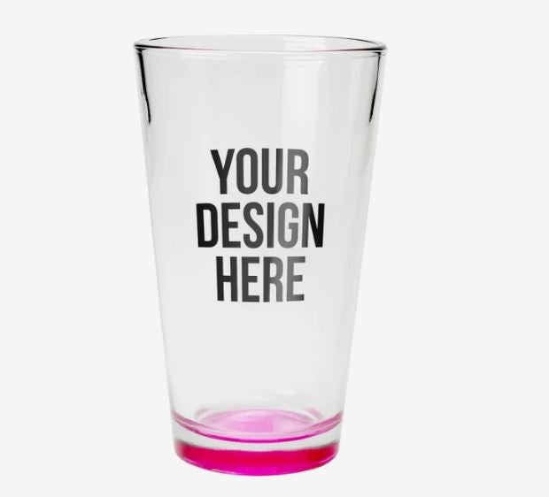 A photo of a tall shot glass with a pink bottom and with YOUR DESIGN HERE printed on it.