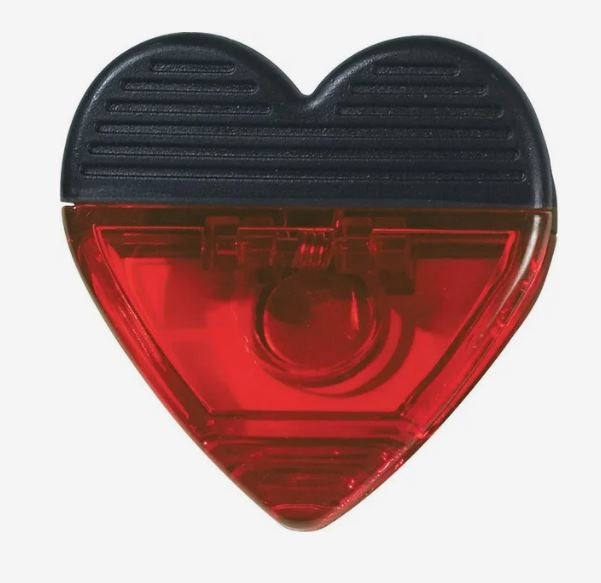 A photo of a red and black heart-shaped transparent plastic clip.