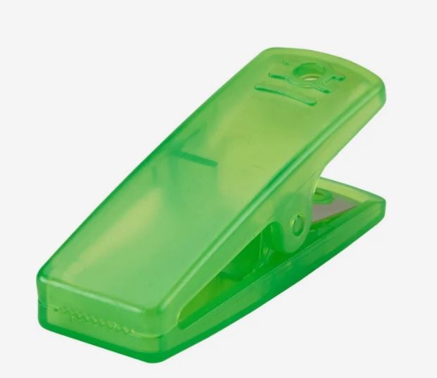 A photo of a transparent green plastic clip.