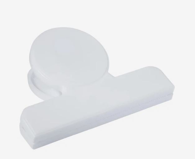 A photo of a white plastic clip.