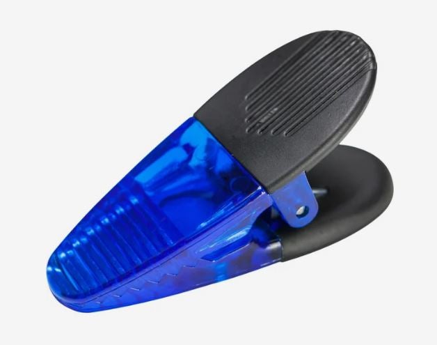 A photo of a transparent blue plastic clip.
