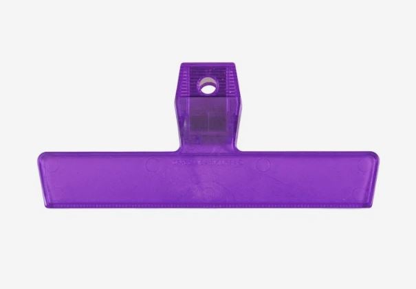 A photo of a purple plastic clip.