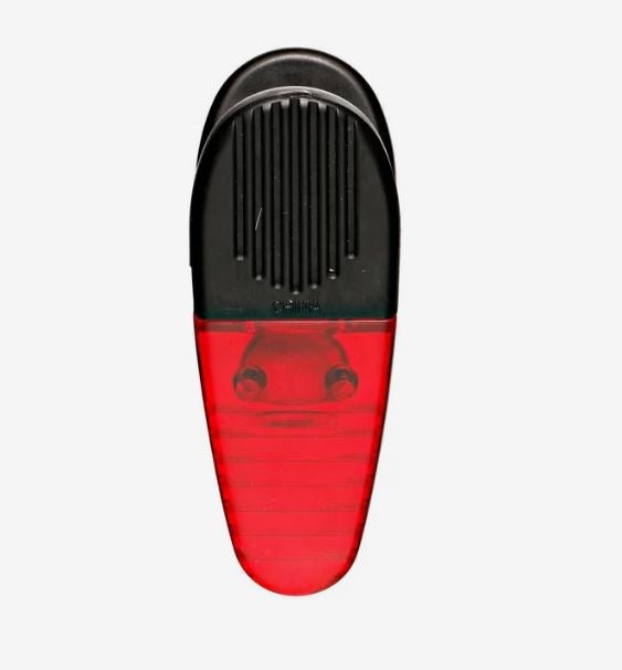 A photo of a transparent red plastic clip.
