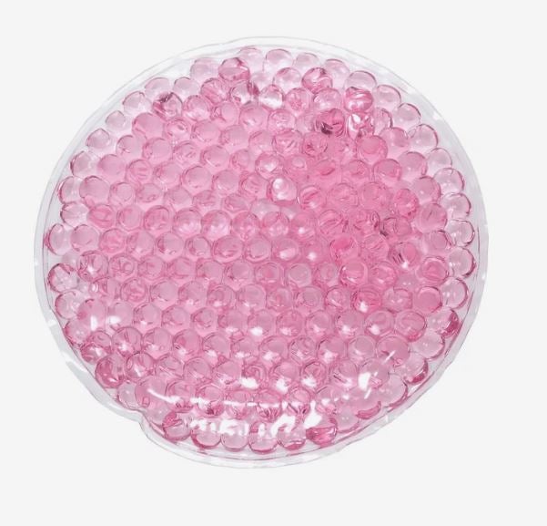 A photo of a pink circle gel bead hot/cold pack.