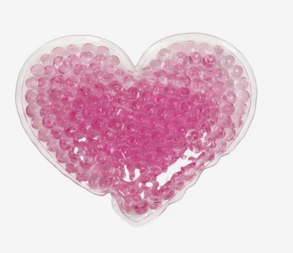 A photo of a pink heart-shaped hot/cold gel bead pack.