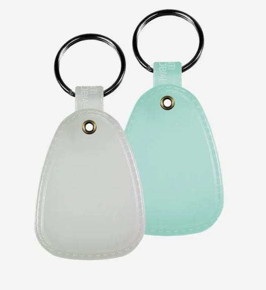 A photo of two glow in the dark key tags, one in purple and one in blue, on separate split ring keychains.