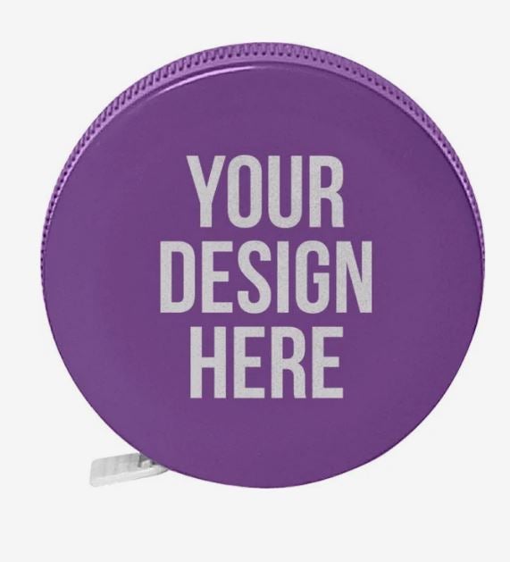 A photo of a round plastic purple tape measure with YOUR DESIGN HERE printed on it in white.