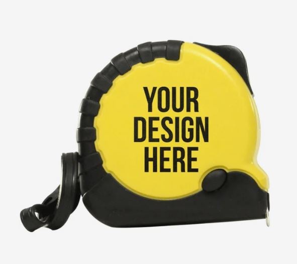 A photo of a black and yellow tape measure with YOUR DESIGN HERE printed on it in black.