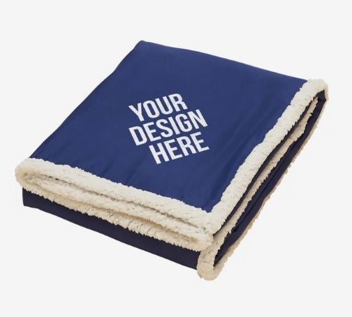 A photo of a blue blanket with a white sherpa lining and YOUR DESIGN HERE on the top in white.