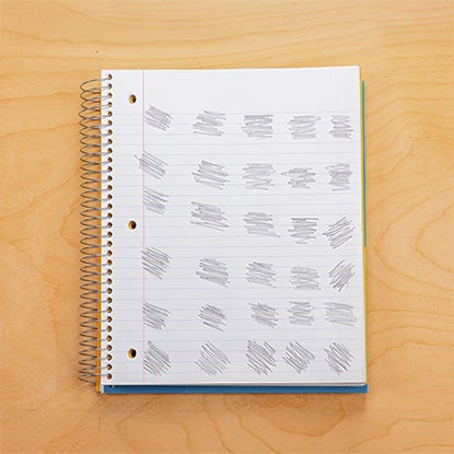A photo showing a notebook with 30 pencil scribbles in a grid.