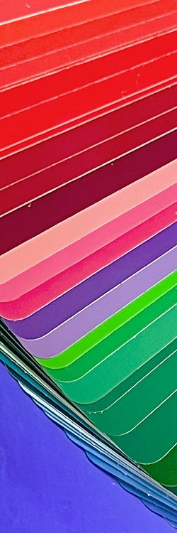 A photo showing layers of colorful sheets of card stacked on top of each other.