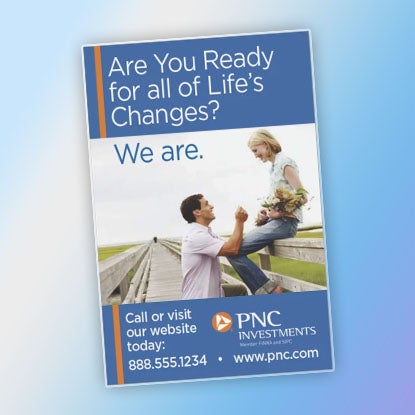 A photo of a rectangular magnet printed with an ad for PNC Investments.