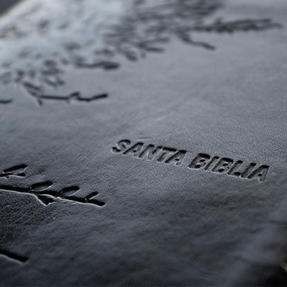A photo showing a close-up of a laser engraver engraving into wood.
