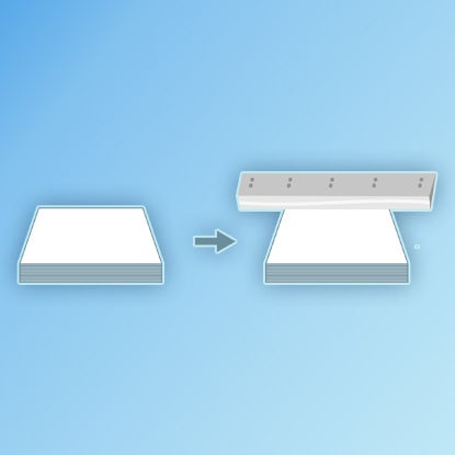 An illustration showing the edges of the notebook being trimmed with a large blade.
