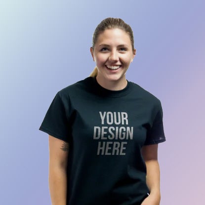 A photo of a smiling white woman wearing a black t-shirt with YOUR DESIGN HERE printed on it in silver.