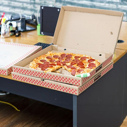 A photo showing pepperoni pizza in a cardboard pizza box.